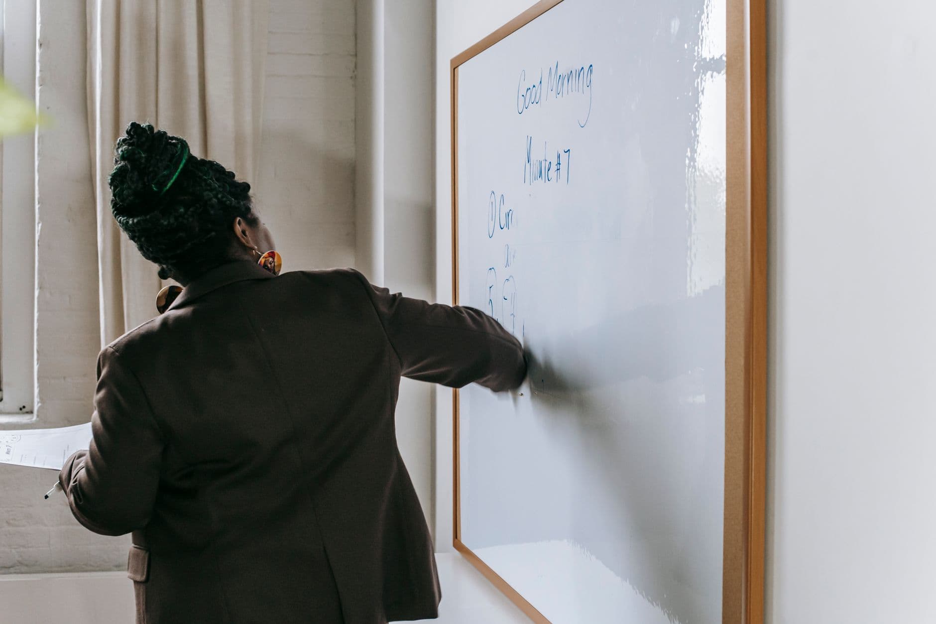 Teacher preparing a lesson at a classroom whiteboard